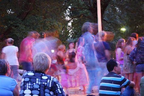 audience dancing in the garden to live music at sunset